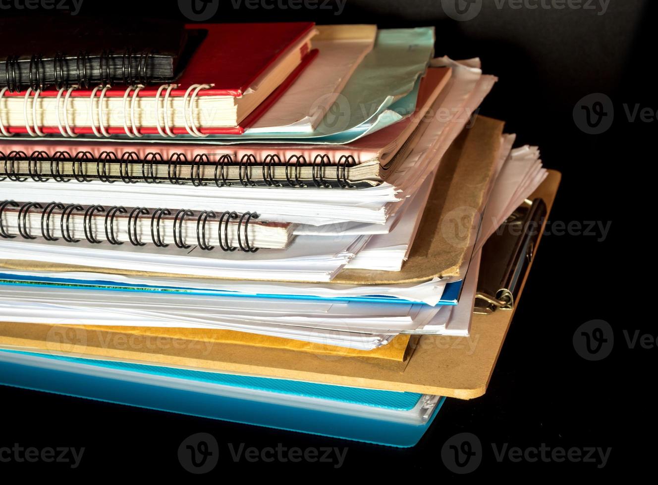 Stacked of office documents paper in the black background photo