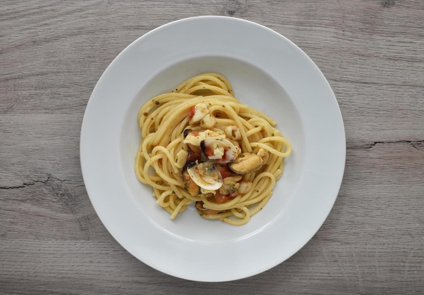 Spaghetti allo scoglio, spaghetti with seafood. Italian pasta with mussels, shrimps and clams. photo