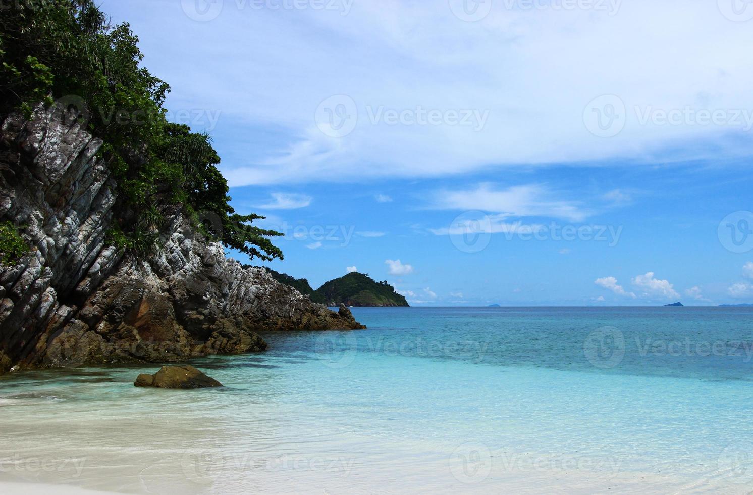 The blue sea and sky with mountain and rock photo