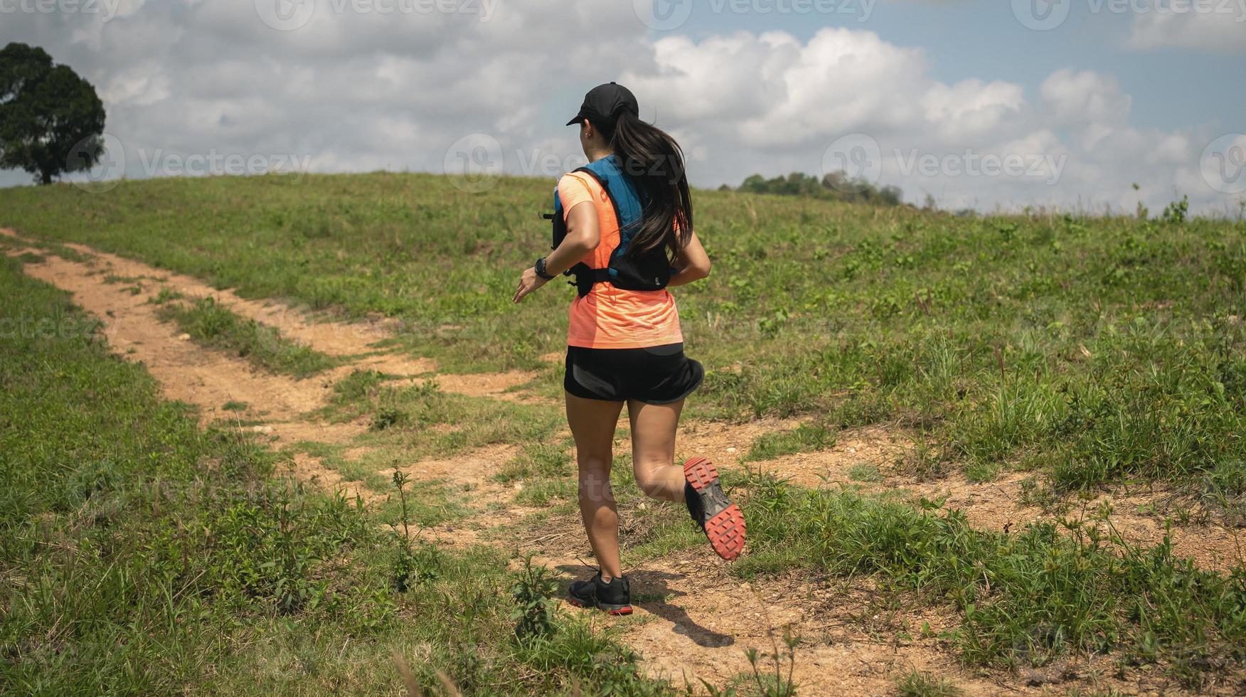 Young women active trail runners the top of a mountain in the afternoon, ultra marathon runners adventuring outdoors photo