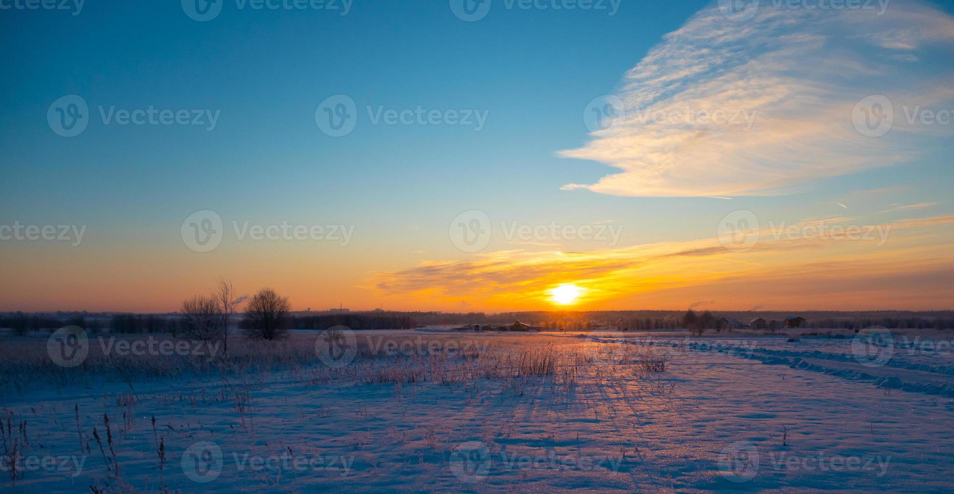 The beautiful sunset with tracks in snow winter background photo