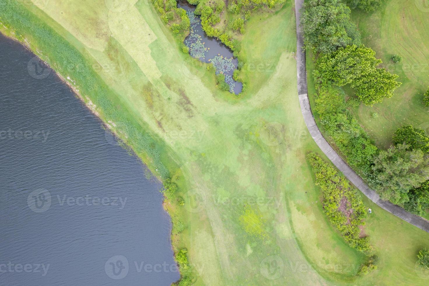 Aerial view drone shot of beautiful green golf field fairway and putting green Top down image for sport background and travel nature background Amazing view photo