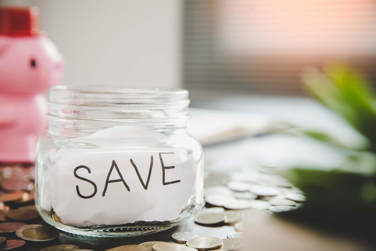 Coins in glass jar for money saving photo