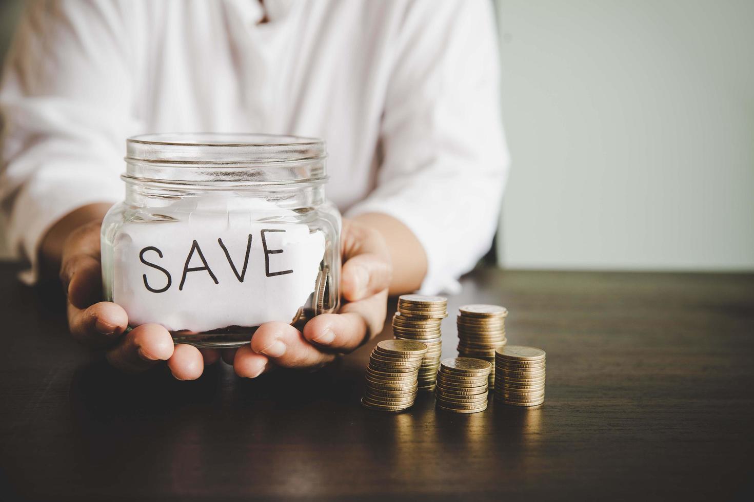 Coins in glass jar for money saving photo