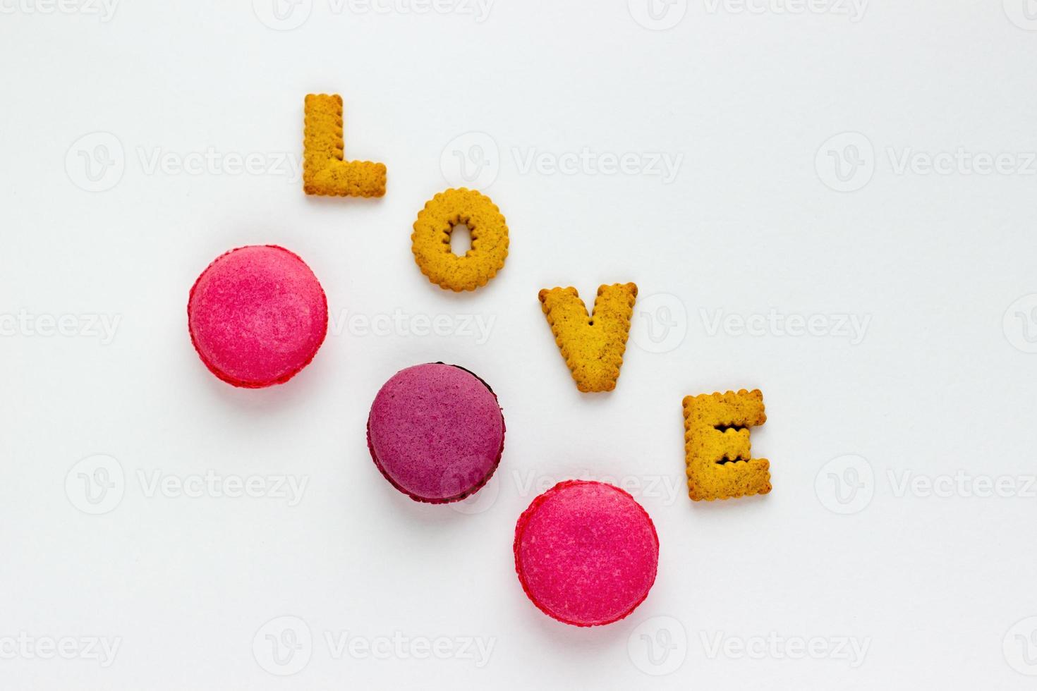 Sweet food minimalist background with cookies and pink macaroons. photo