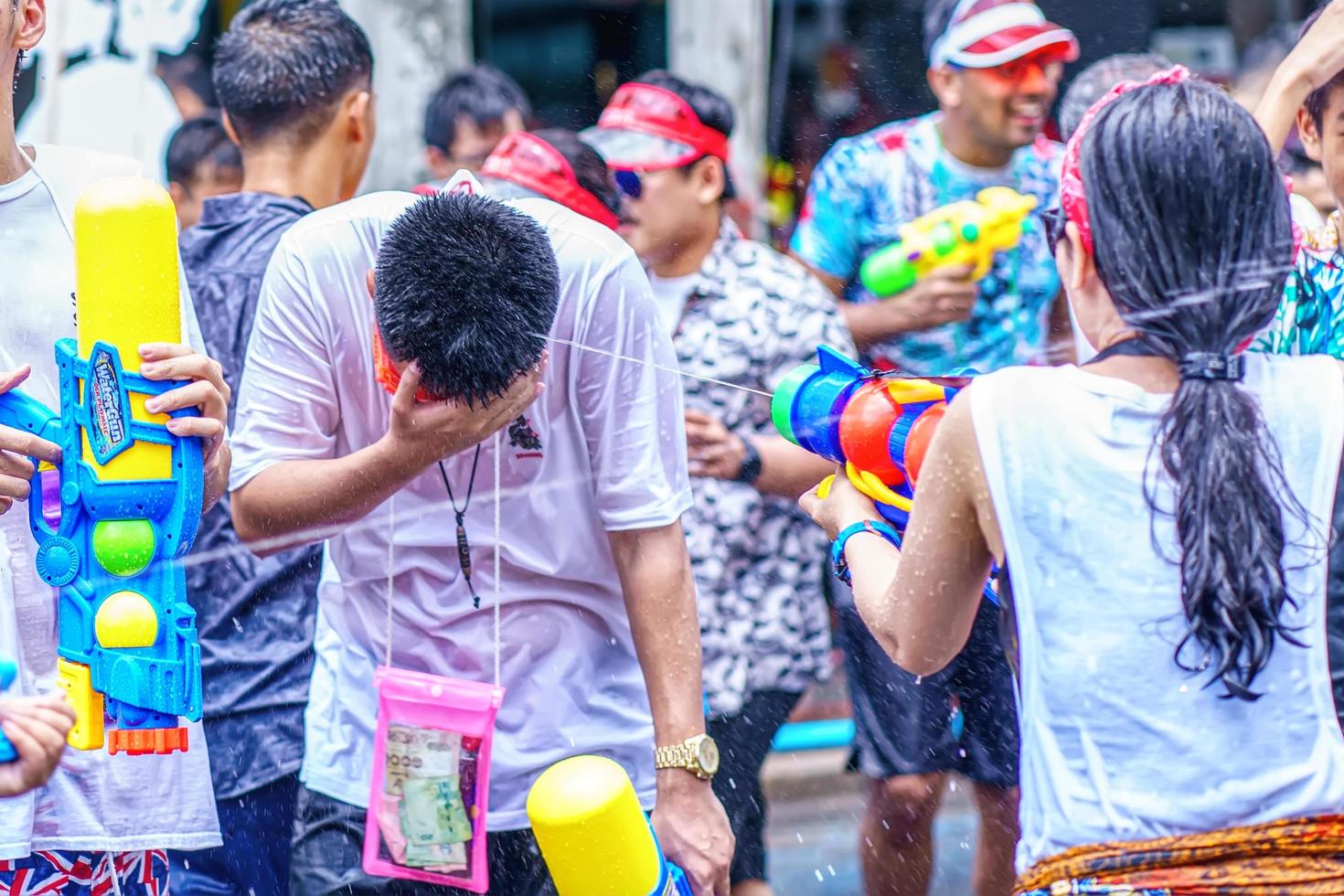 Songkran Festival or Songkran is celebrated in Thailand as the traditional New Year's Day from 13 to 15 April. People getting soaked during Songkran. photo