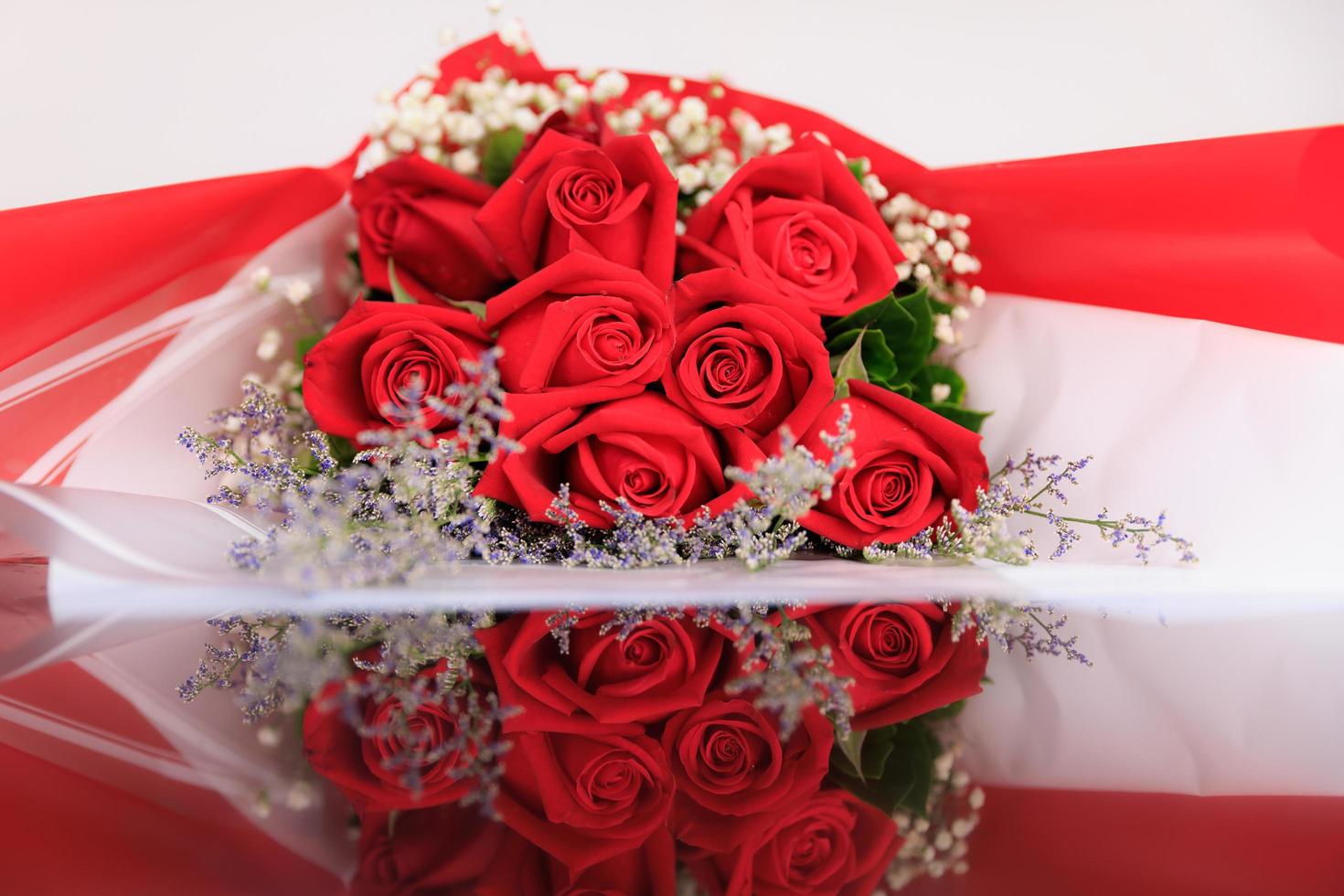 A big, elegance and luxury bouquet made of red roses with reflection on floor photo
