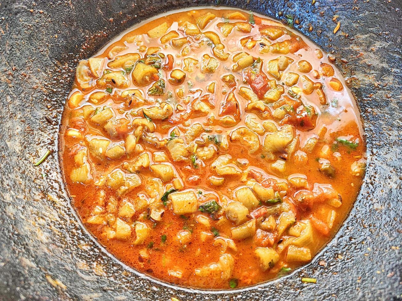 Tori ki sabji  - spicy Ridge gourd curry - in dark wok photo
