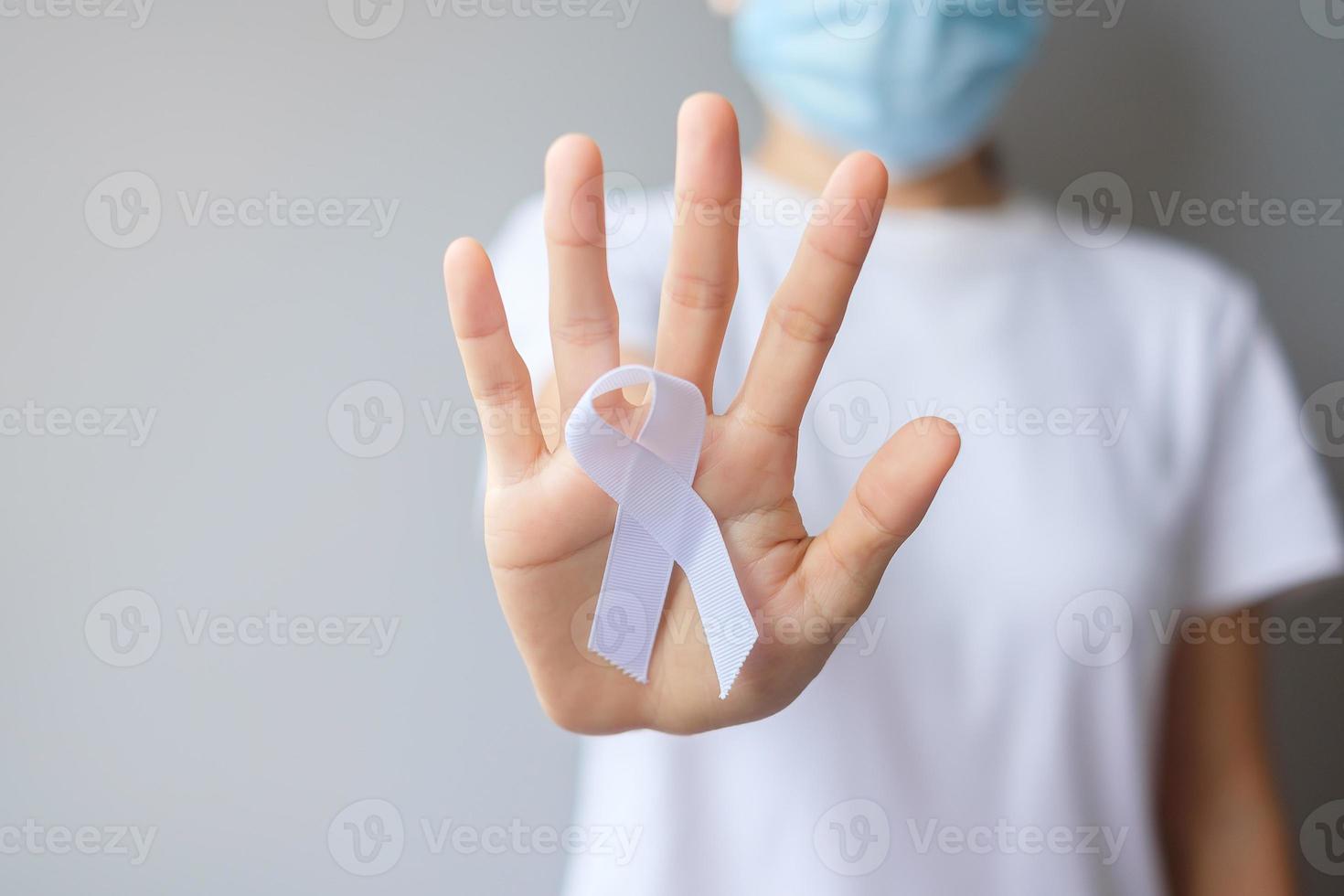Woman holding white Ribbon for November Lung Cancer Awareness month, democracy and international peace day. Healthcare concept photo