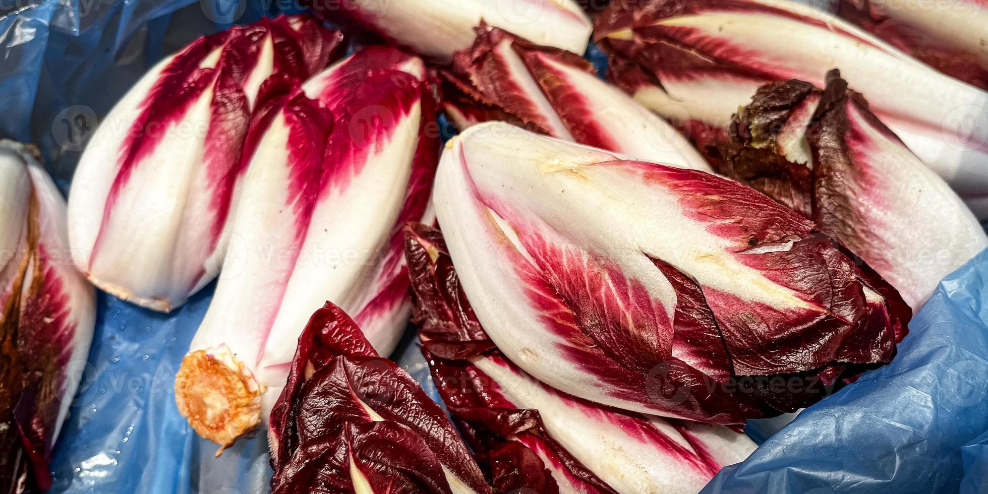 chicory salad fresh Belgian endive or chicory and red Radicchio vegetables fresh ripe fruit counter in the market shop healthy meal food diet snack veggie vegan photo