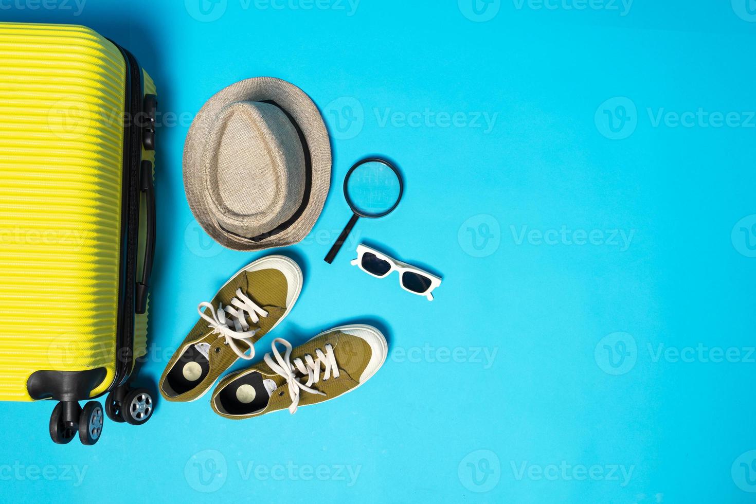 Man accessories lying flat on textured fabric background top view travel concept photo