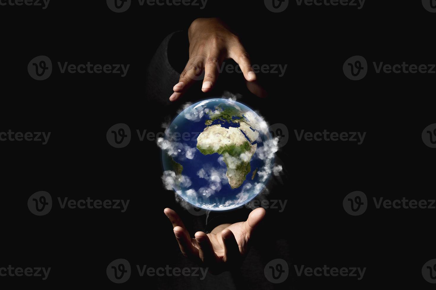Environment concept. Earth in human hands on black background. Elements of this image furnished by NASA photo