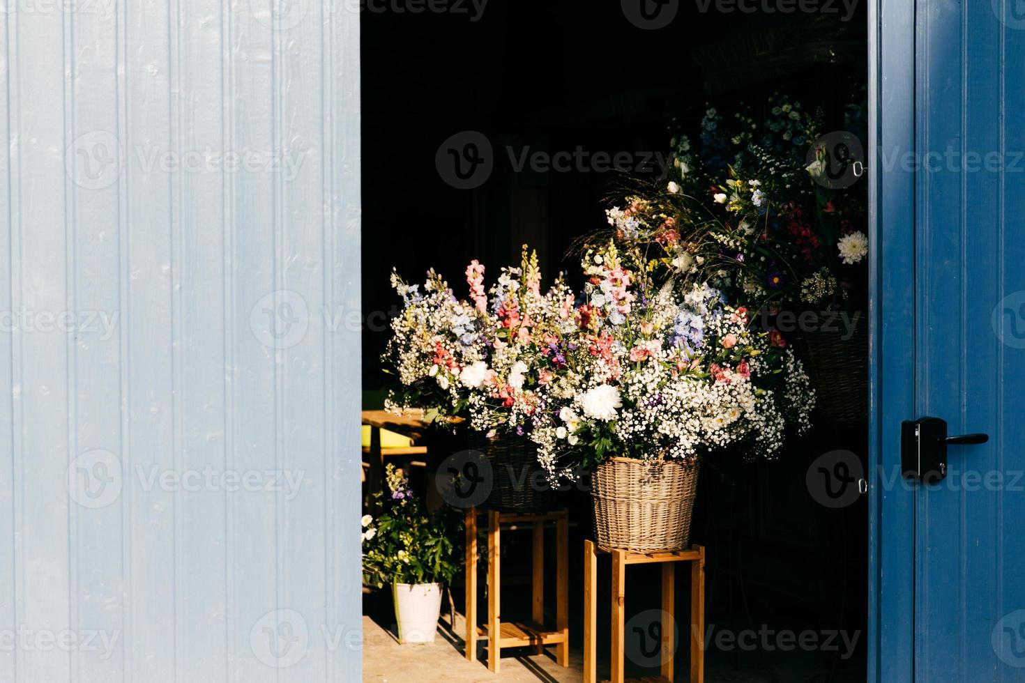 Beautiful flowers with pleasant smell in wooden backet. Bouquet of beautiful flowers with nice odour standing on chair in wooden backet. Blooming flowers photo