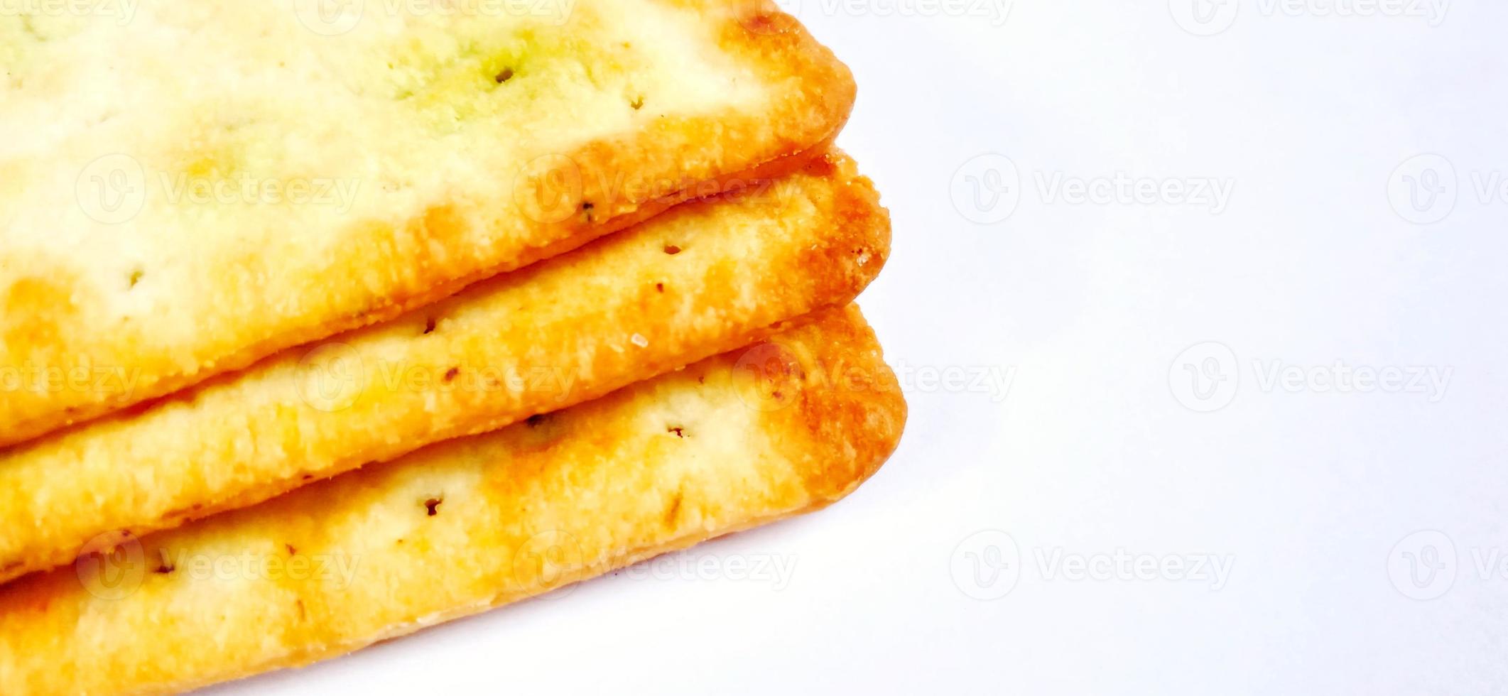 Sugarless and vegetable healthy cracker biscuit slices on the gray white studio background. Food background design. Suitable for promotion of food and beverage industry and company, food advertising. photo