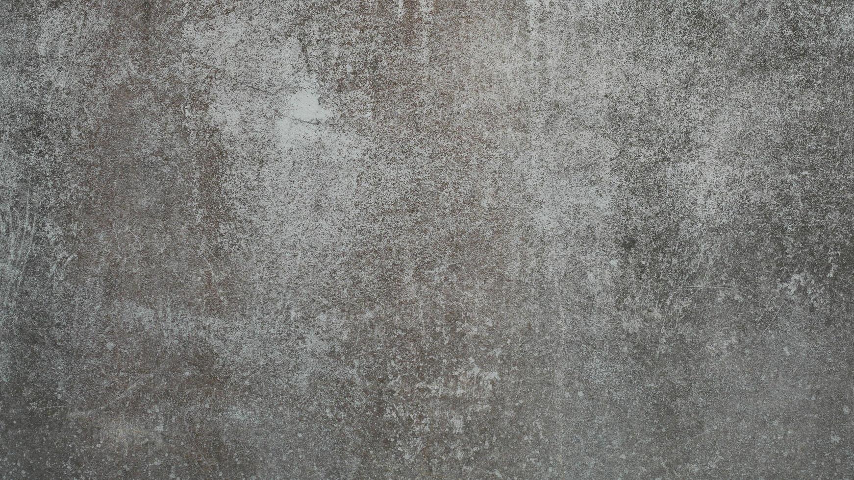 The old cement wall was weathered, the surface was scratched, the surface was scratched and damaged. For a mysterious retro-conservative background. photo