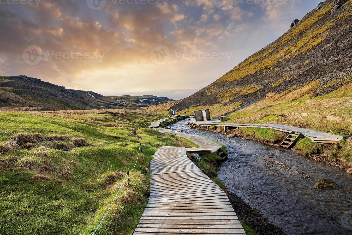 Beautiful view of boardwalk by geothermal stream in Hveragerdi valley at sunset photo