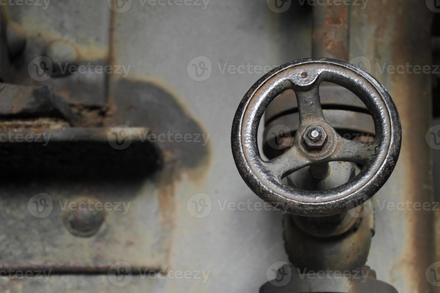 Weathered valve in abandoned steel factory photo