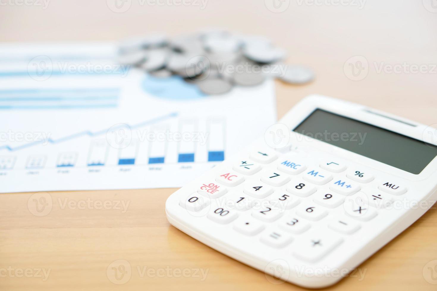 Calculator and stack of coins photo