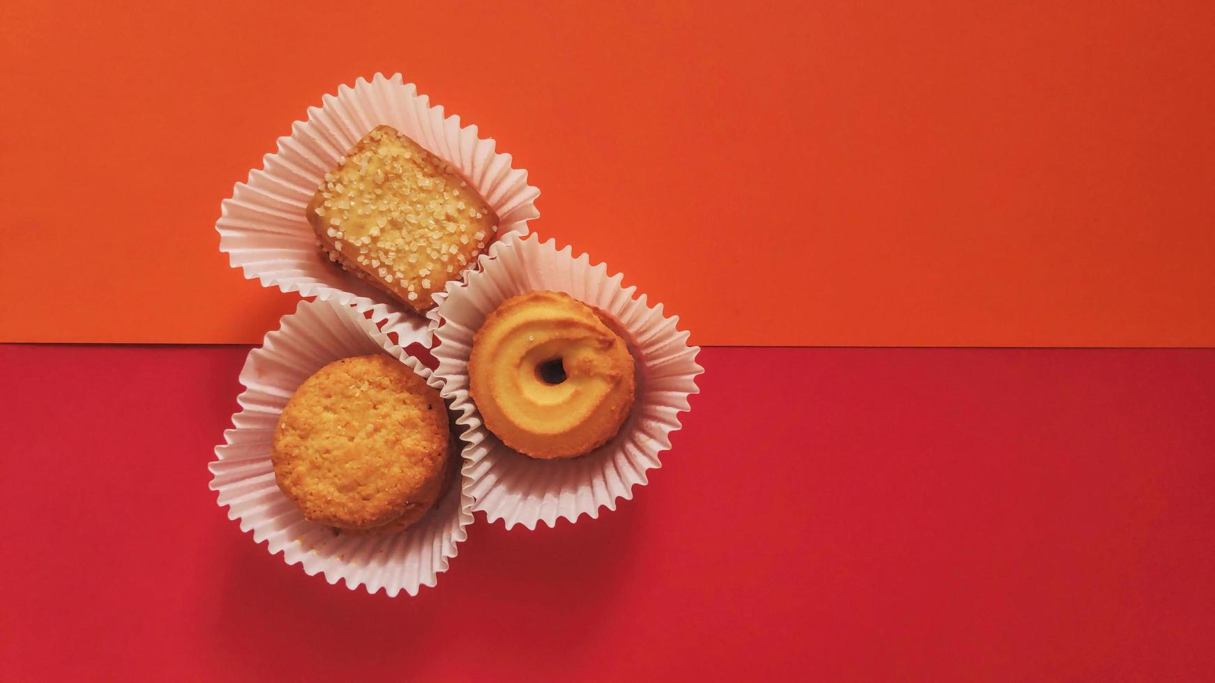 shapes of cookies in stack on red background photo