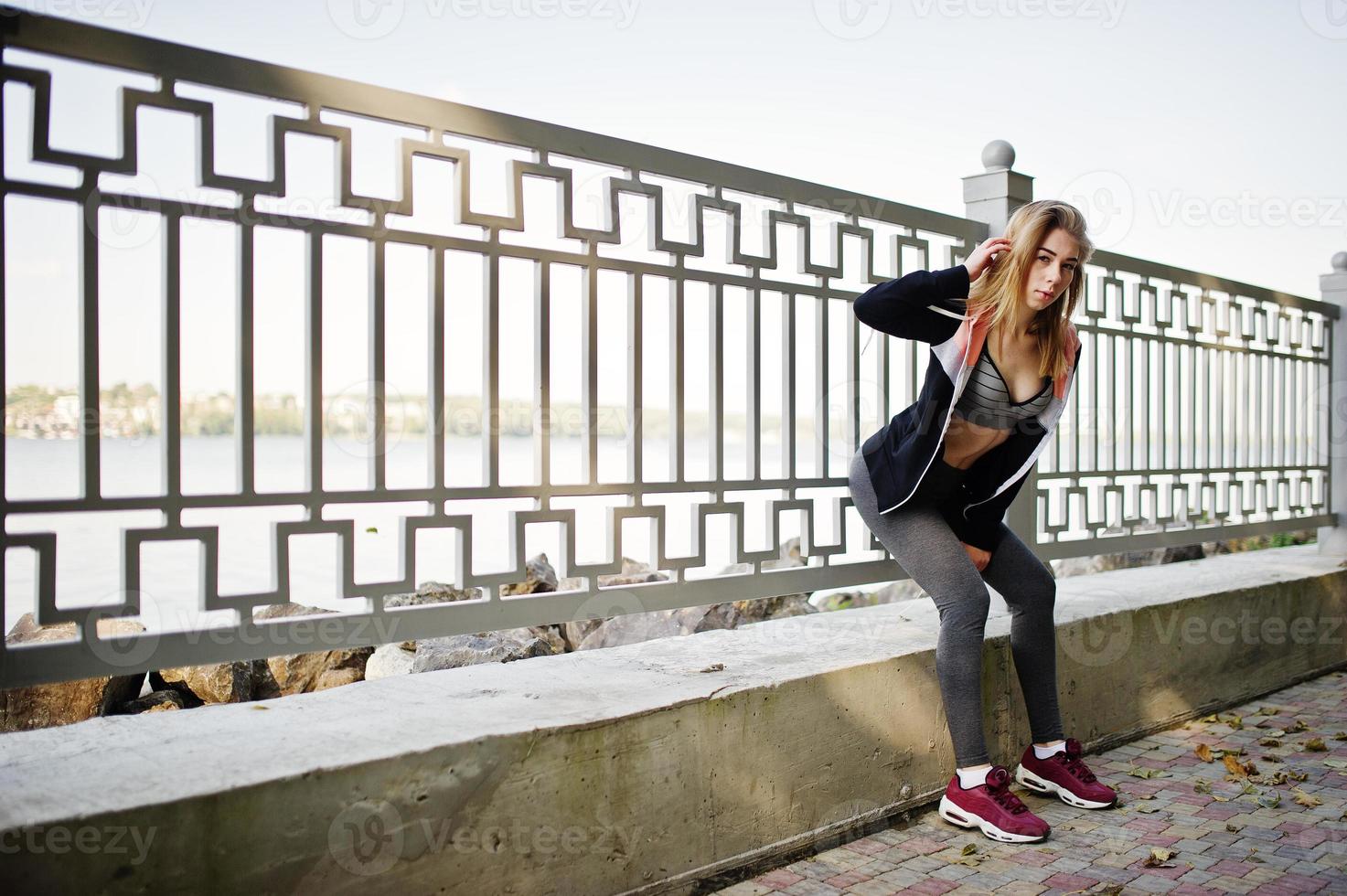 la joven tiene el entrenamiento y hace ejercicio al aire libre. deporte, fitness, concepto de entrenamiento callejero. foto