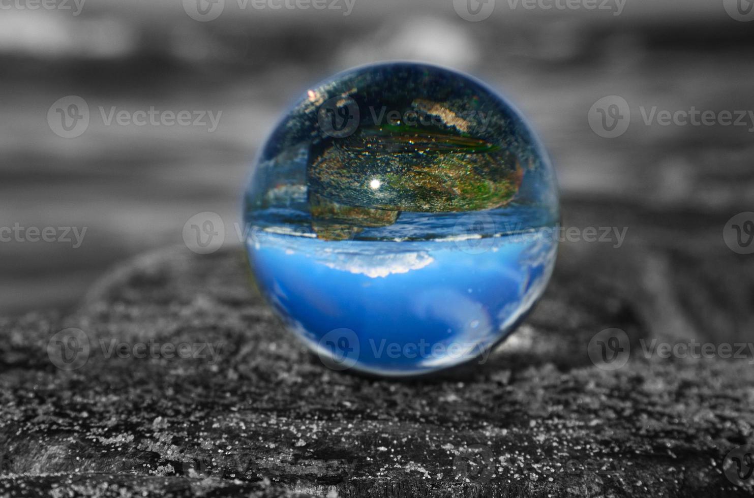 glass globe on the beach of the baltic sea. photo