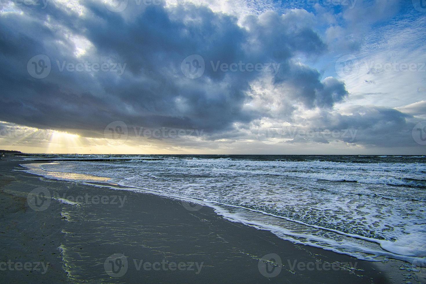 View over the dunes to the Baltic Sea at sunset photo