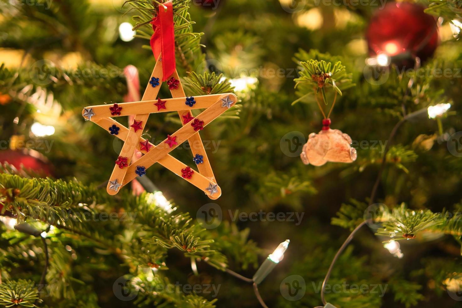 Christmas. Christmas decoration. Poinsettia made of wood hangs on Christmas tree photo