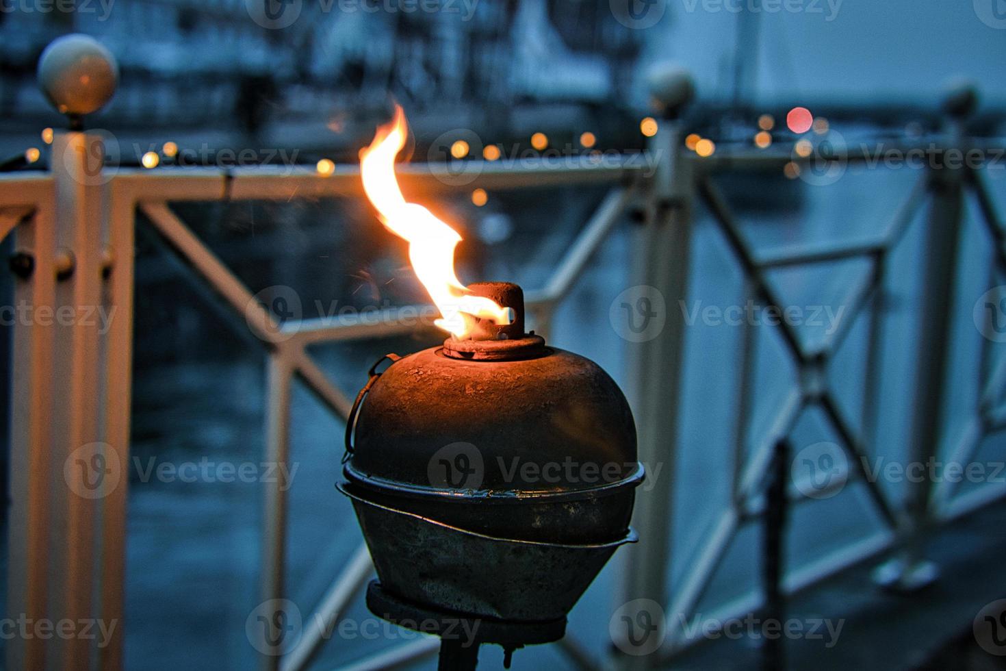 Burning oil lamp by the water in relaxed mood in Blavand photo