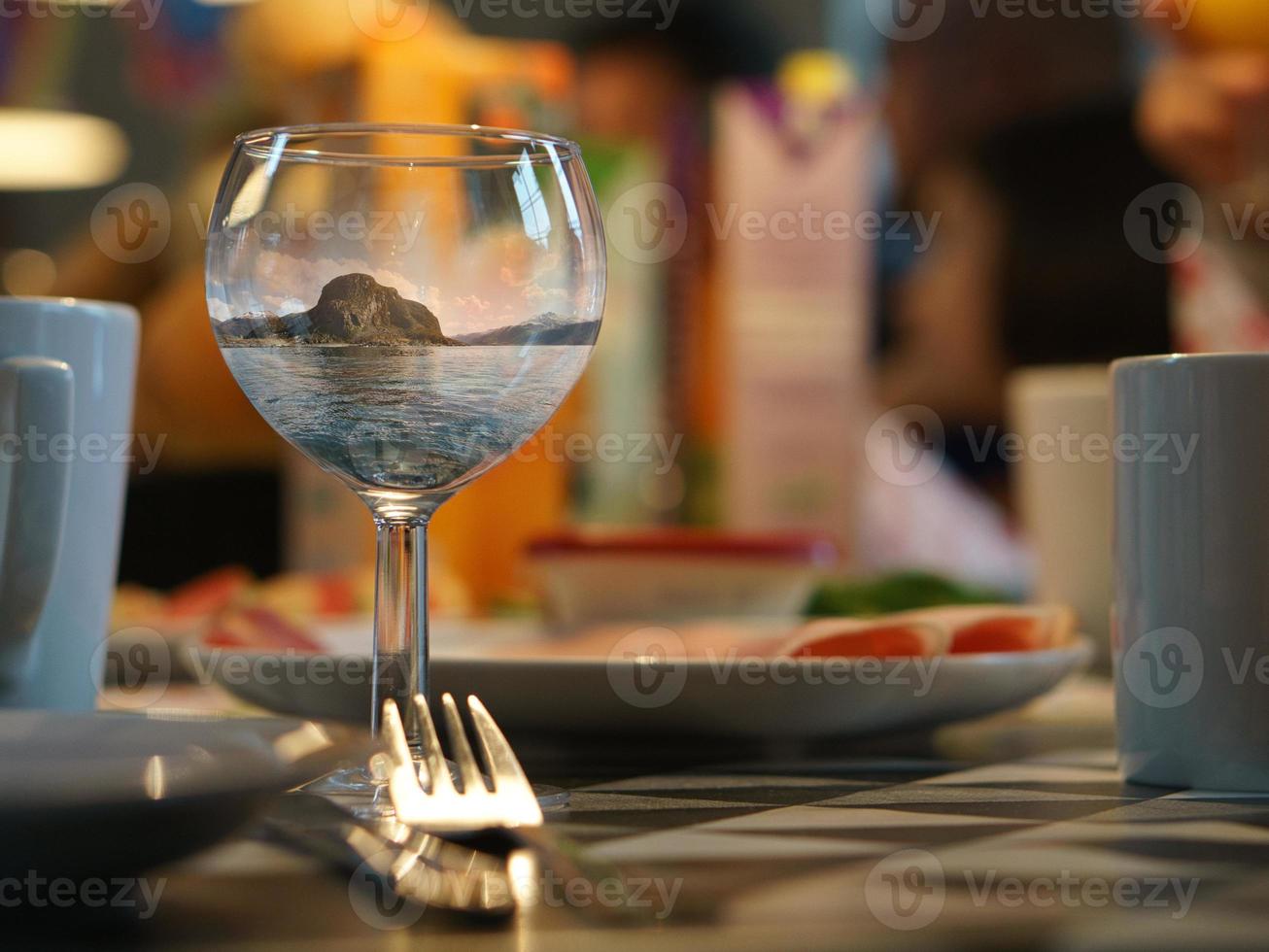 Fantasy image composing of a wine glass with the landscape from Norway.Creative idea photo