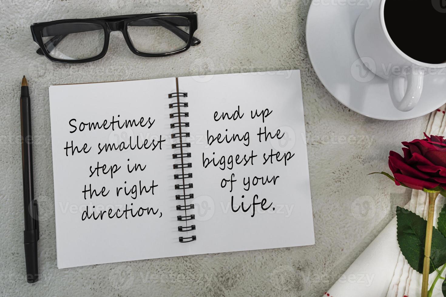 Motivational and inspirational quote on notebook on white marble table. photo