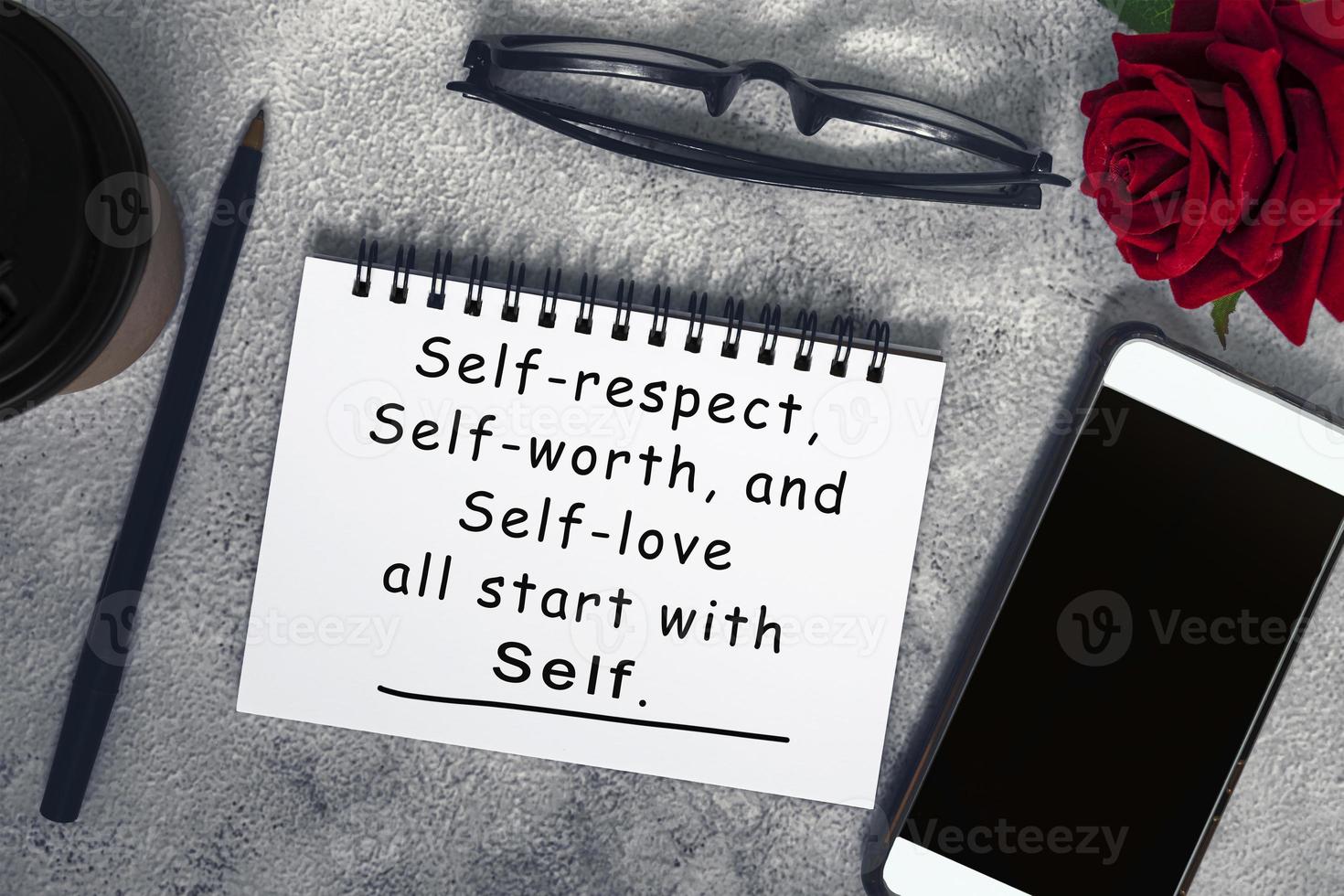 Motivational and inspirational quote on a note book on marble table. photo