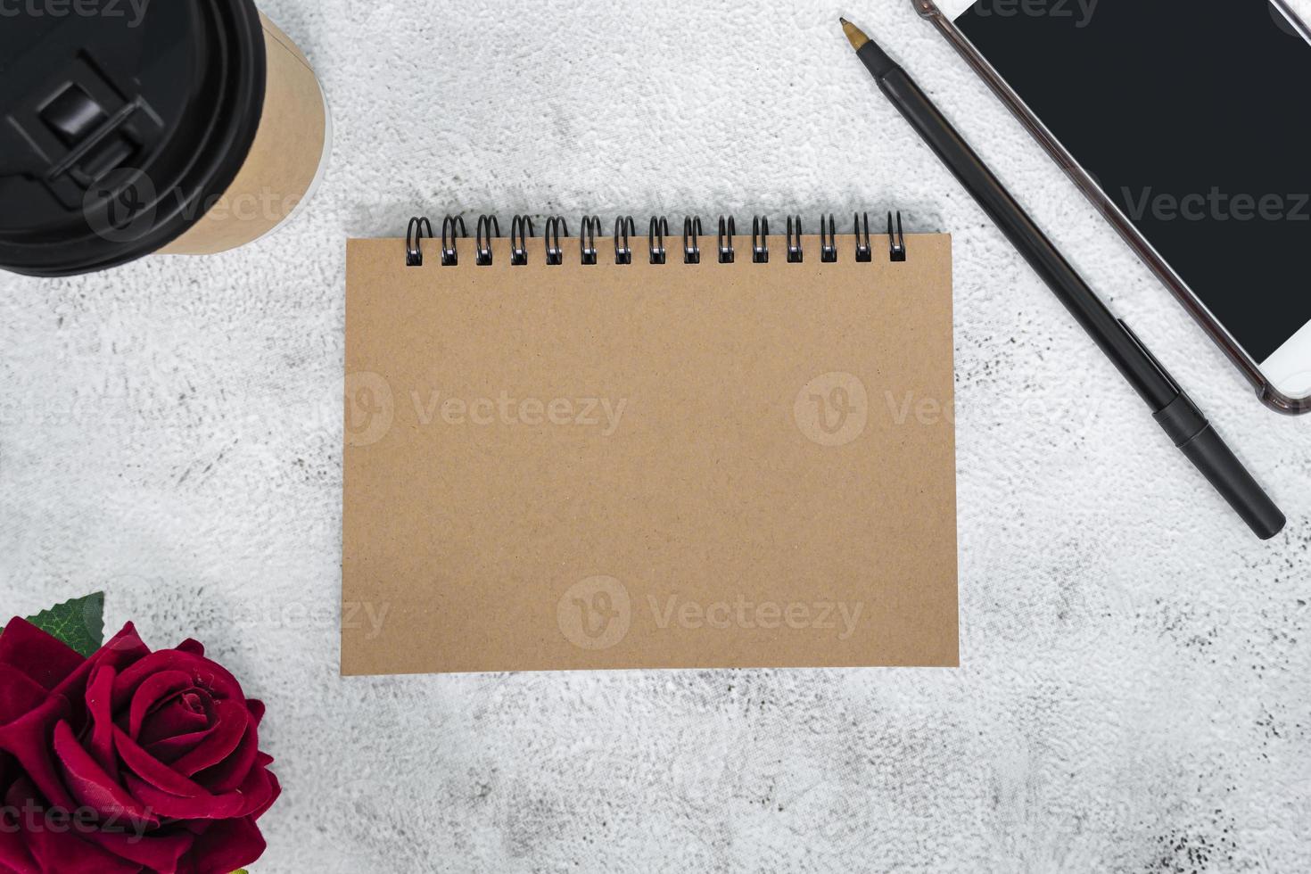 Brown note book on marble desk. Directly above. Flat lay. Copy space. photo