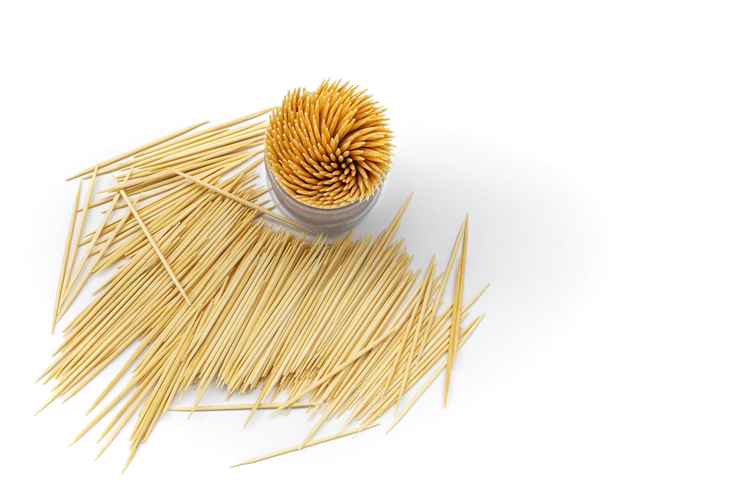 Pile of round wooden toothpicks on white background. Copy space. photo