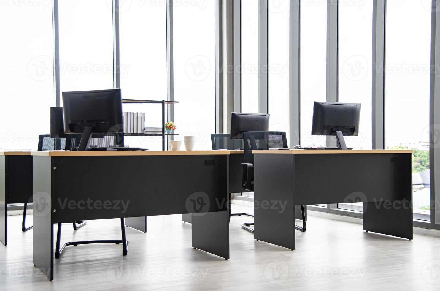Modern office interior design with table, computer,  monitor, big glass window around the room without people photo