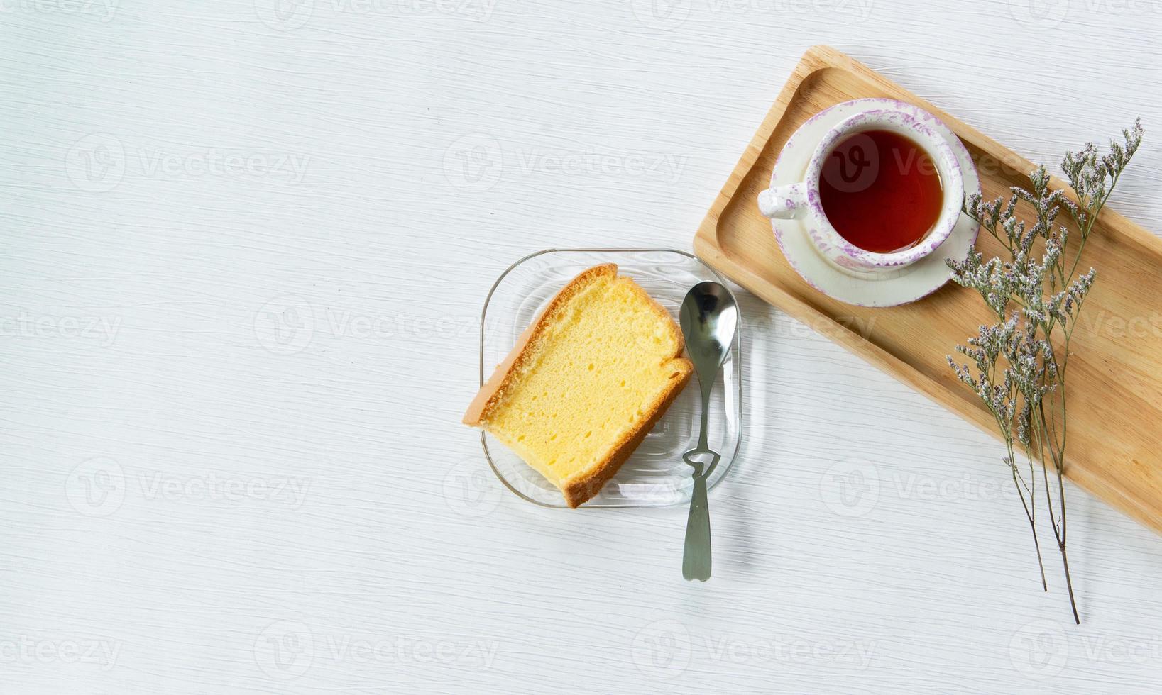 Having breakfast with Chinese tea with soft cake decorated with dried flower at work from home workspace. photo