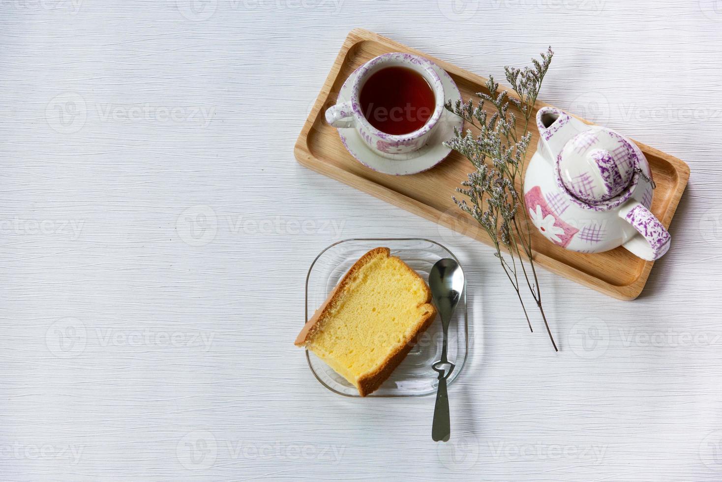 Having breakfast with Chinese tea with soft cake decorated with dried flower at work from home workspace. photo