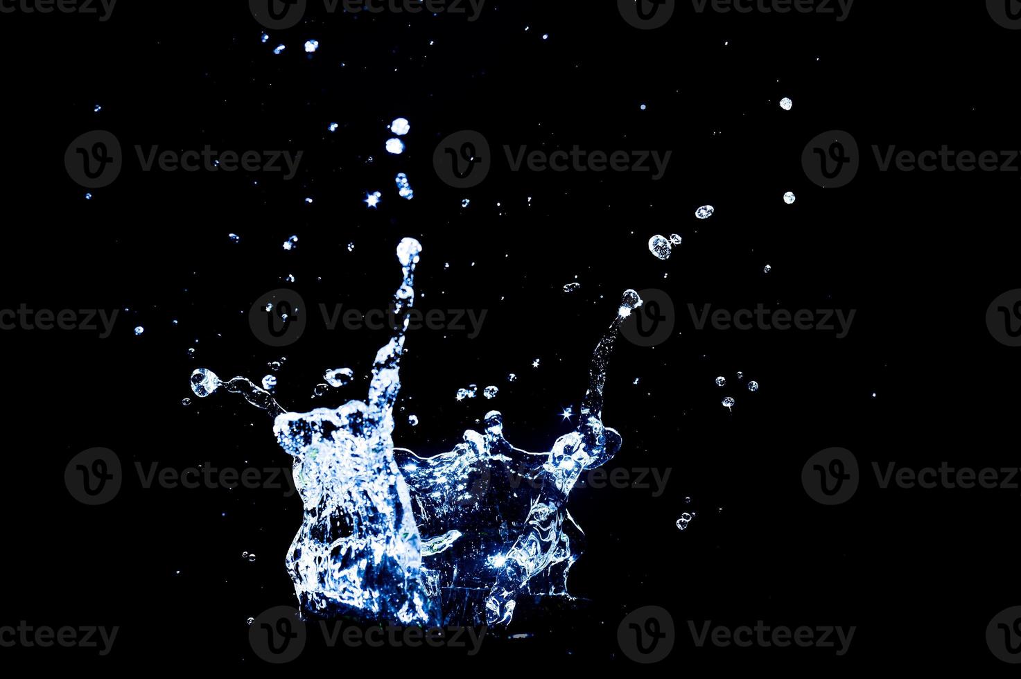 Scattered water splashes on a black background. water splash isolated on the black background photo