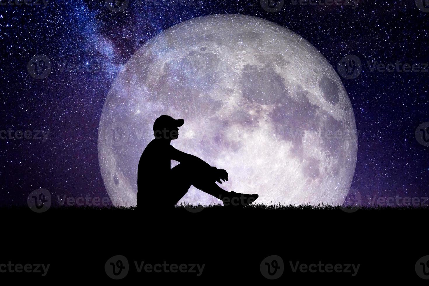 Concept of loneliness and disappointment in love. Sad man sitting element of the picture is decorated by NASA photo