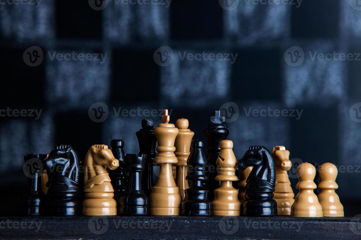 Chess board with chess pieces. Chess on the dark background. Business success concept. Strategy. Checkmate. photo