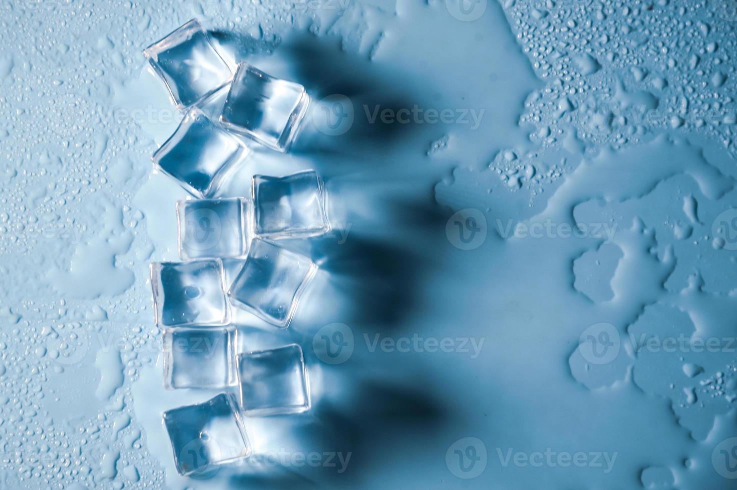 Ice cubes on studio blue background. The concept of freshness with coolness from ice cubes. photo