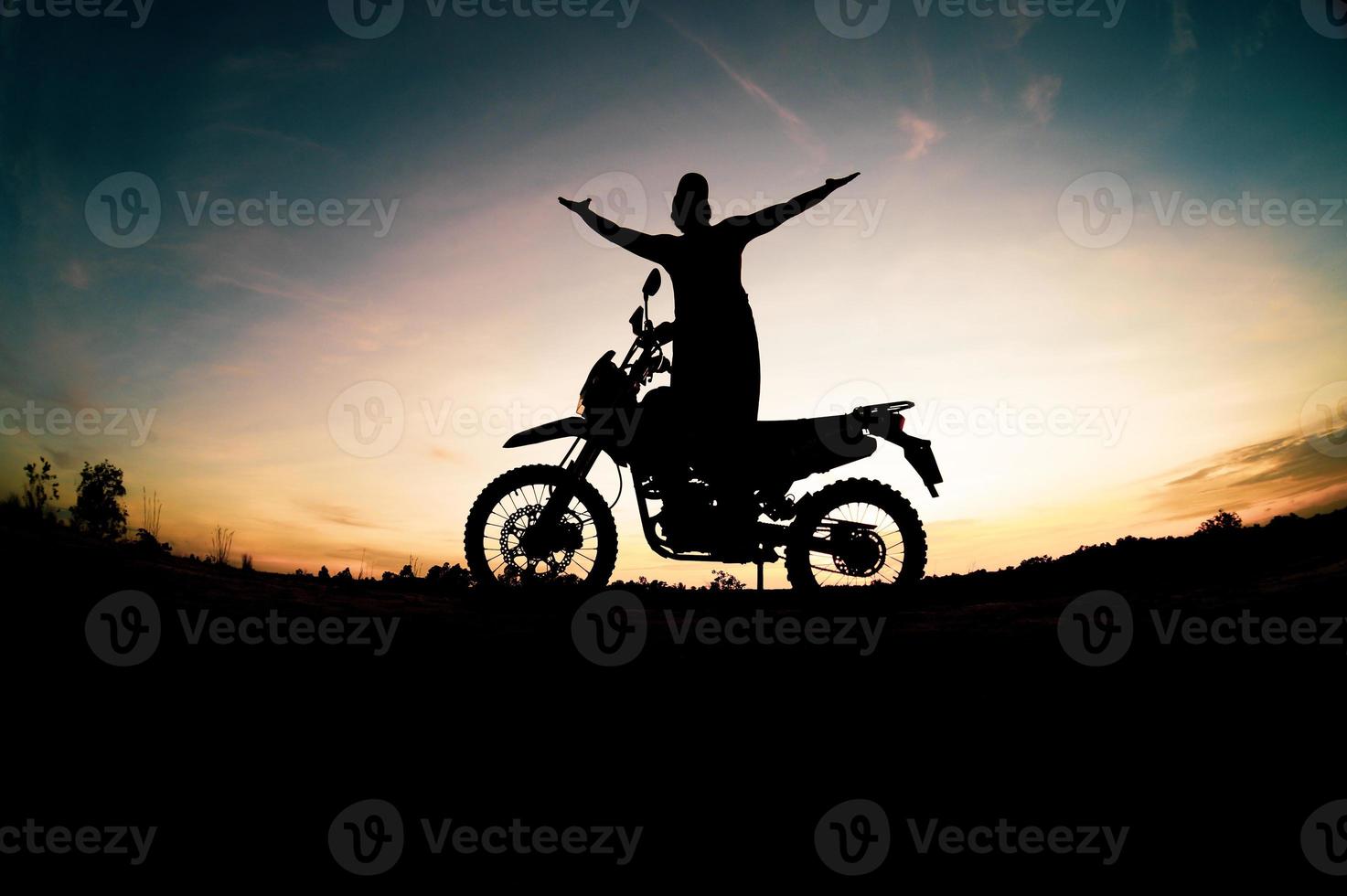 Men's silhouettes and touring motocross bikes. Park to relax in the mountains in the evening. adventure travel and leisure concept photo