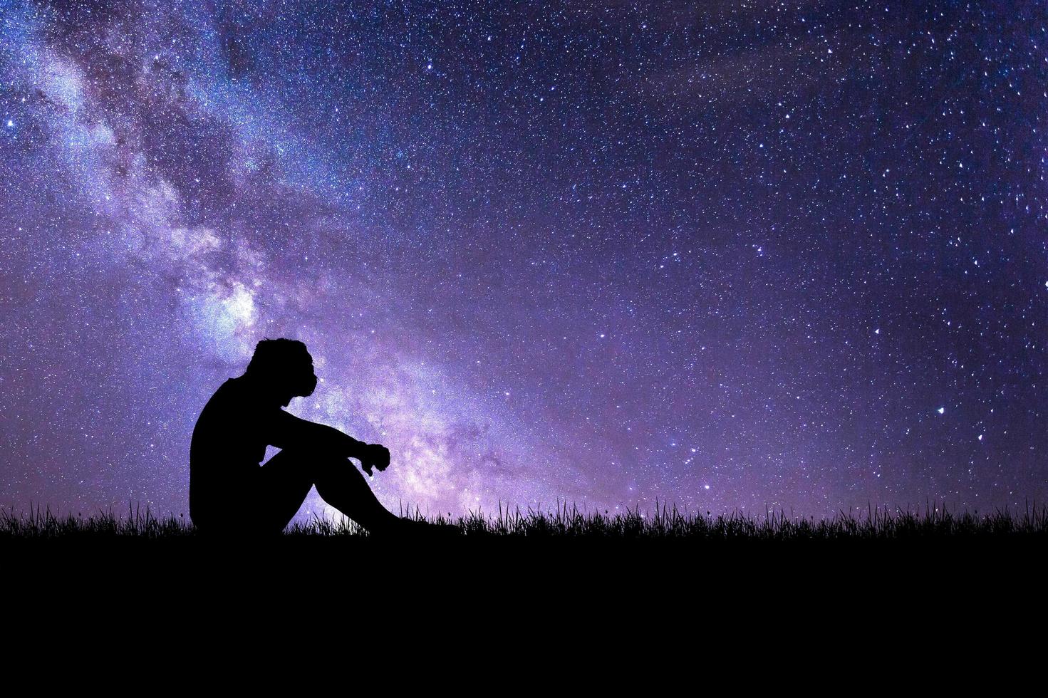 The concept of despair, discouragement, and loneliness. Silhouettes of people sitting with their heads down in sorrow in the meadows. photo