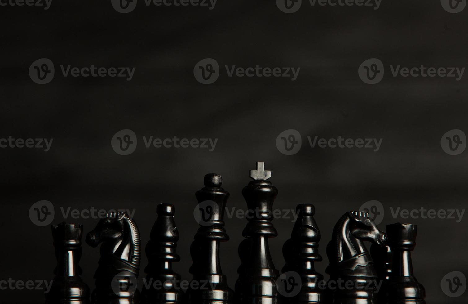 Chess board with chess pieces. Chess on the dark background. Business success concept. Strategy. Checkmate. photo