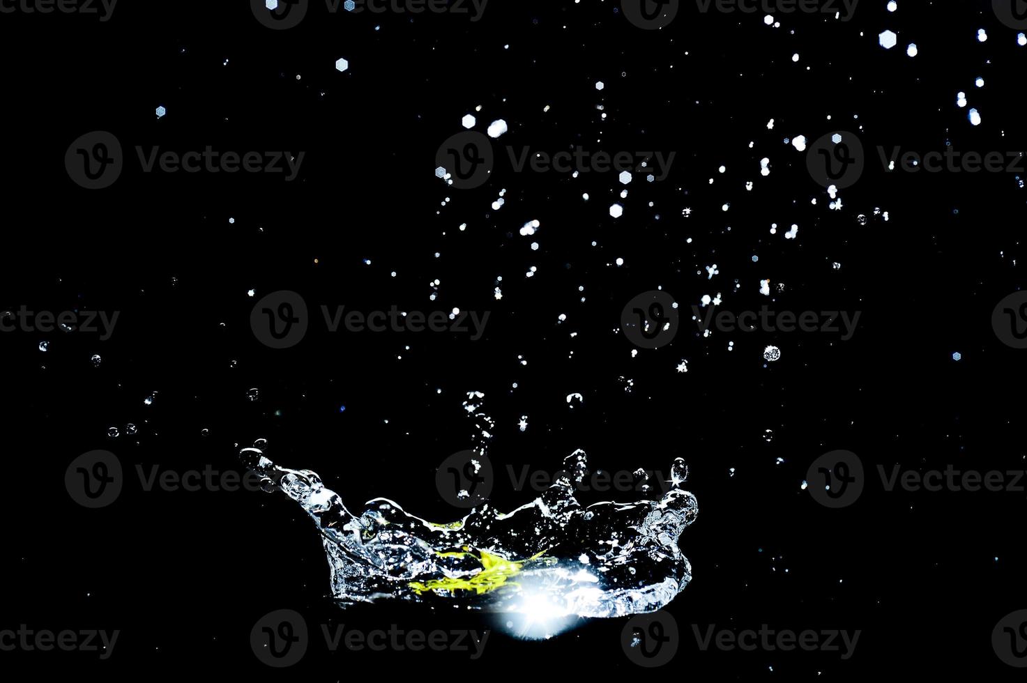 Scattered water splashes on a black background. water splash isolated on the black background photo