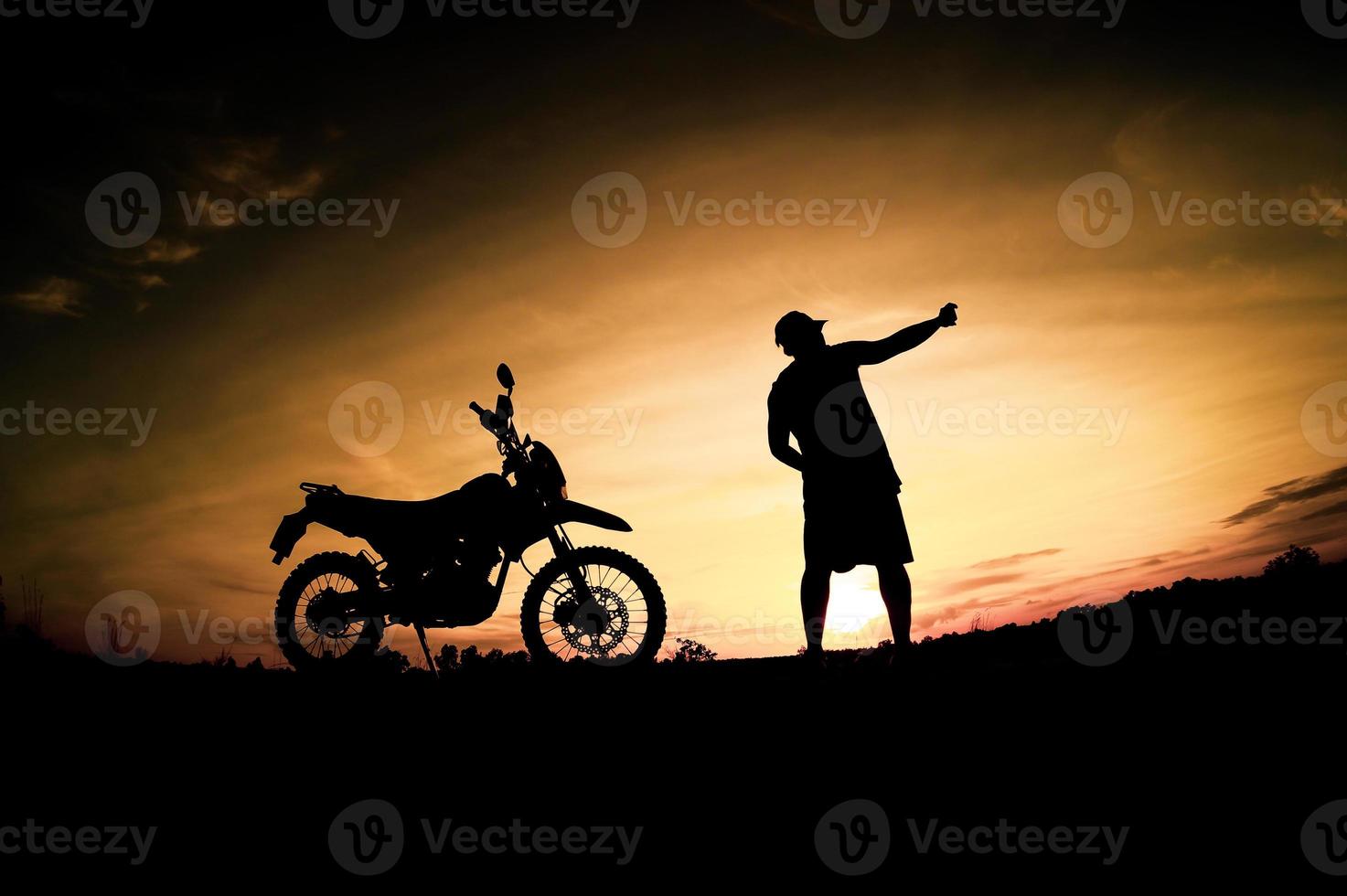 Men's silhouettes and touring motocross bikes. Park to relax in the mountains in the evening. adventure travel and leisure concept photo