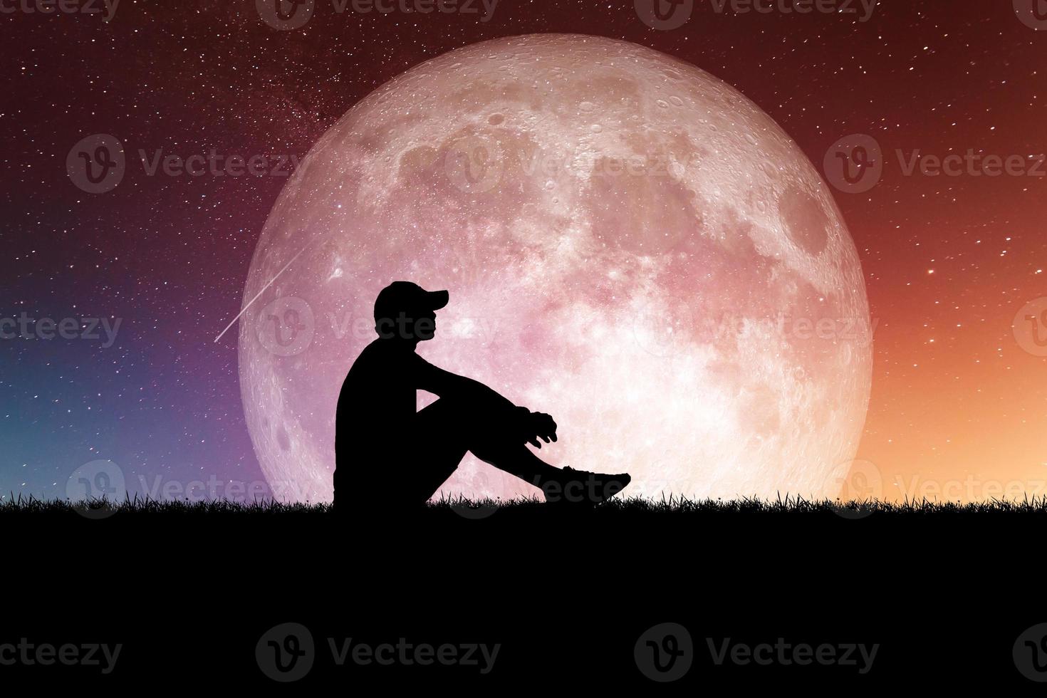 Concept of loneliness and disappointment in love. Sad man sitting element of the picture is decorated by NASA photo