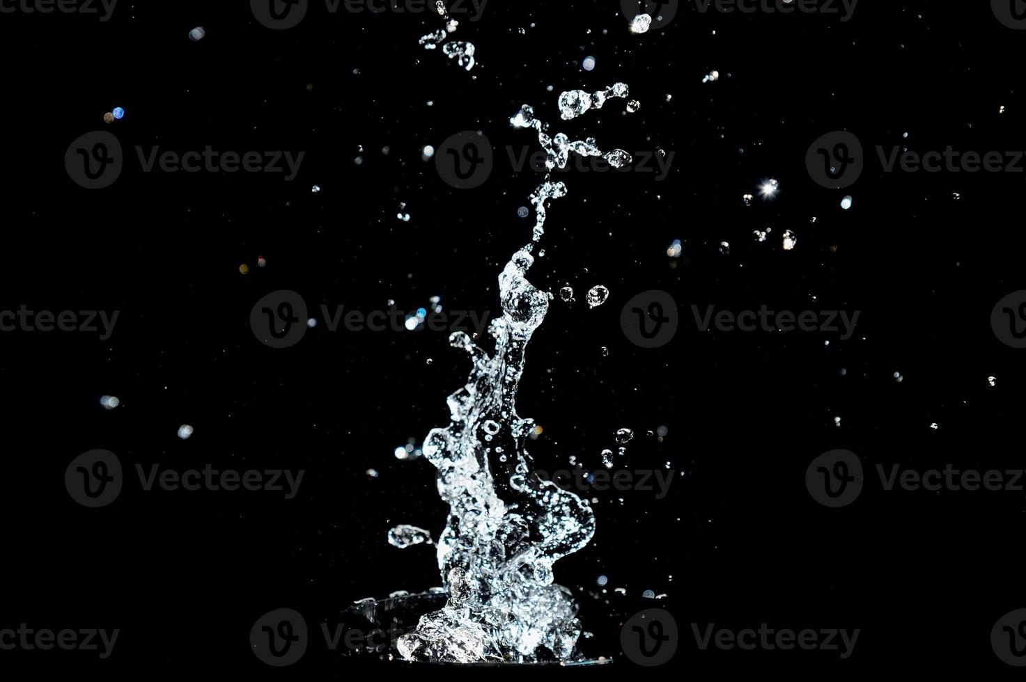 Abstract background of Water splashing on a black background. idea for freshness photo
