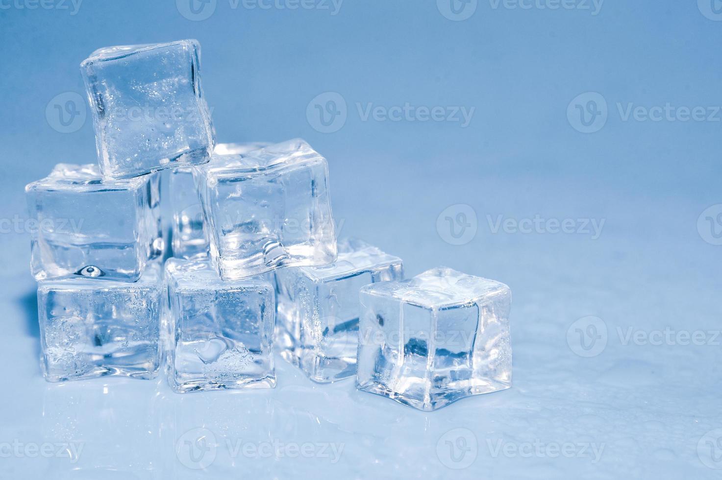 Ice cubes on studio blue background. The concept of freshness with coolness from ice cubes. photo