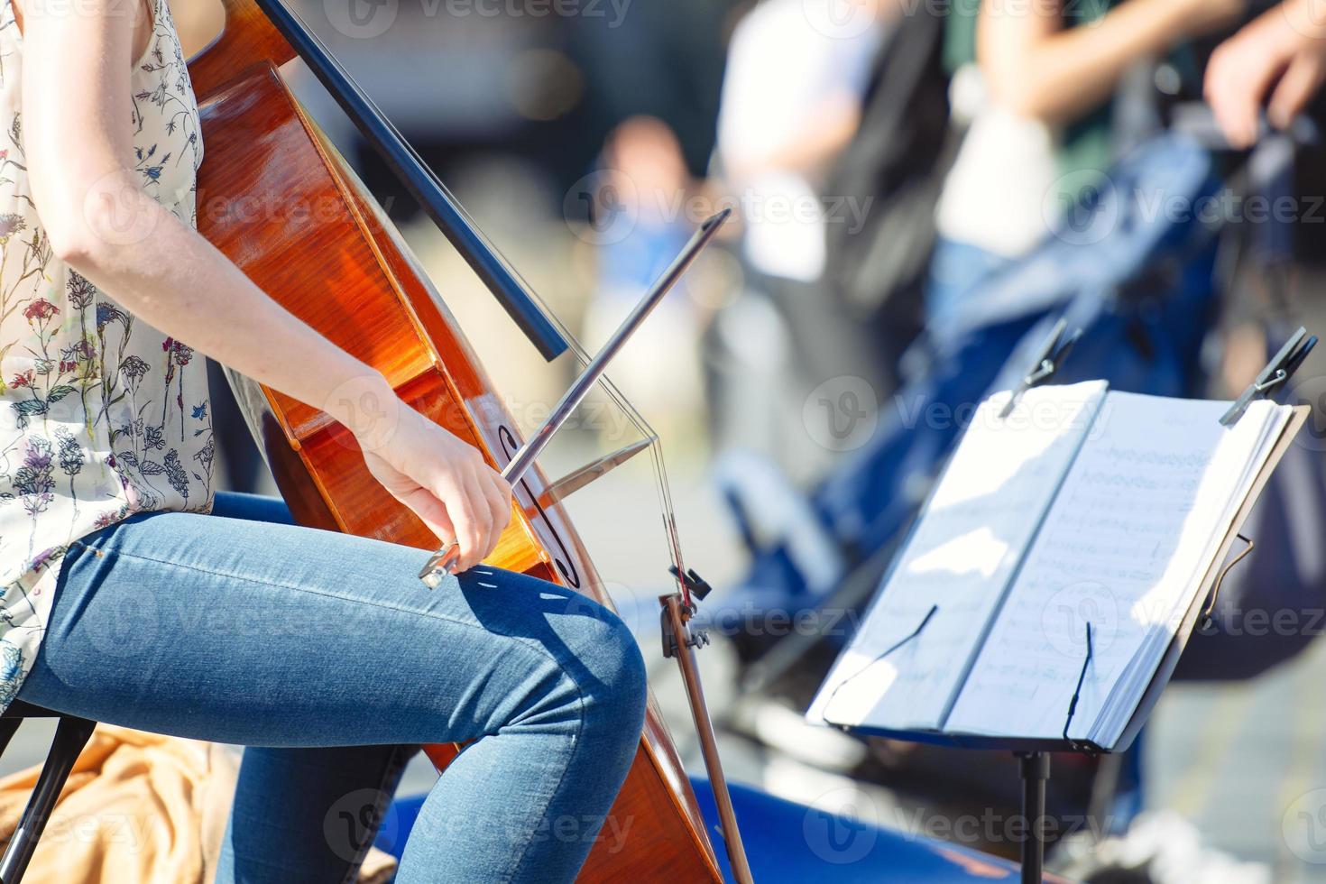 Cello player in the street among the people photo