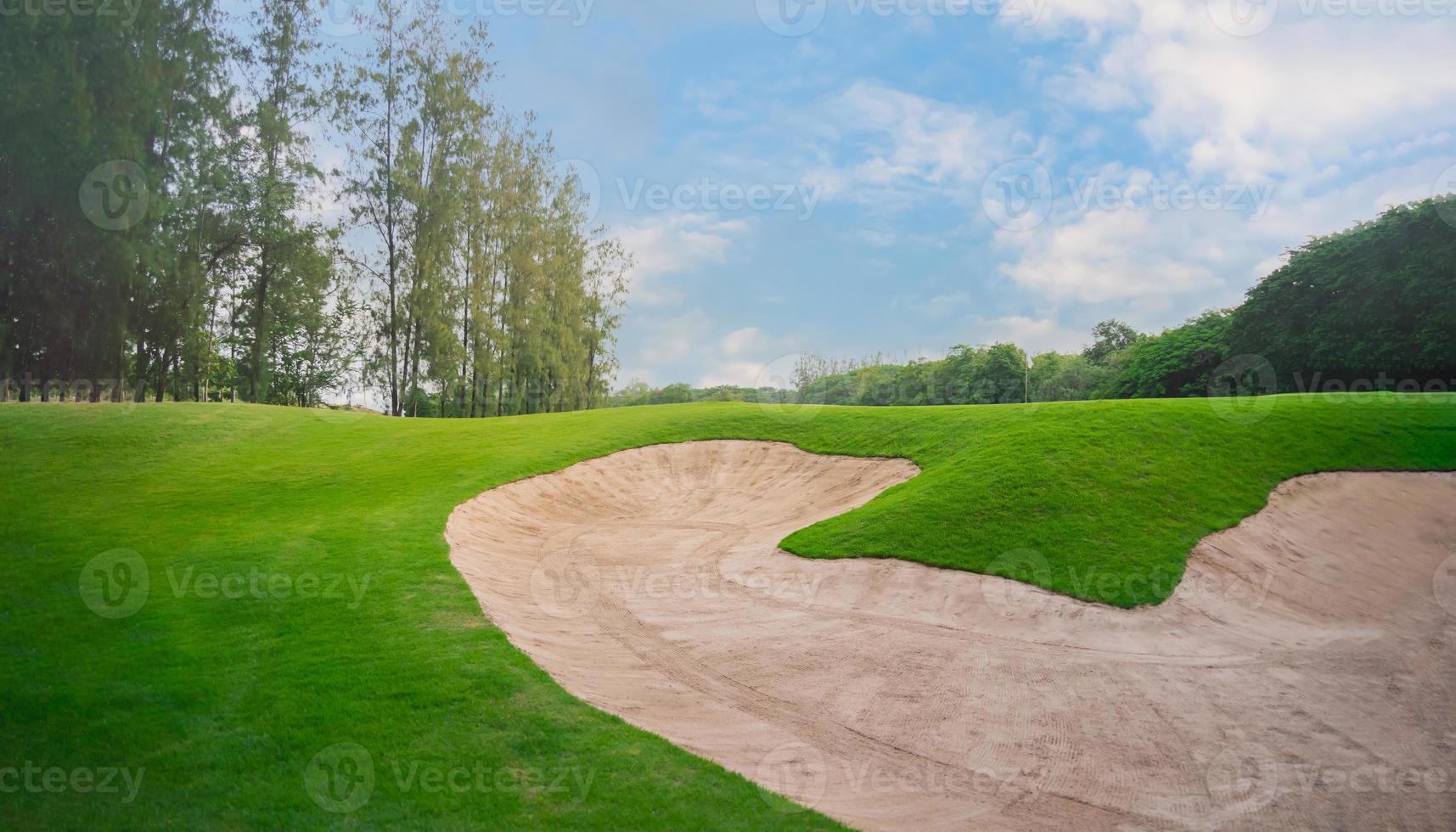 Golf course at the country side. Sand bunkers at the beautiful at sunset, sunrise time.Beautiful view landscape in evening time green grass at golf course. photo